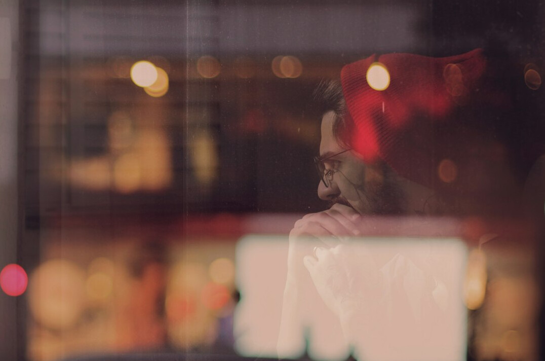 person reflecting by window